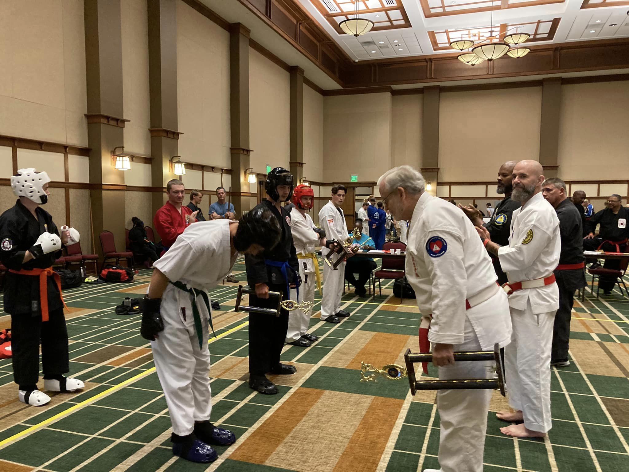 Karate competitors wearing protective gloves during a tournament bout