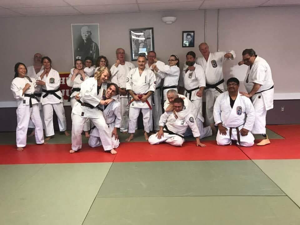 Young karate students and instructors posing for a group photograph