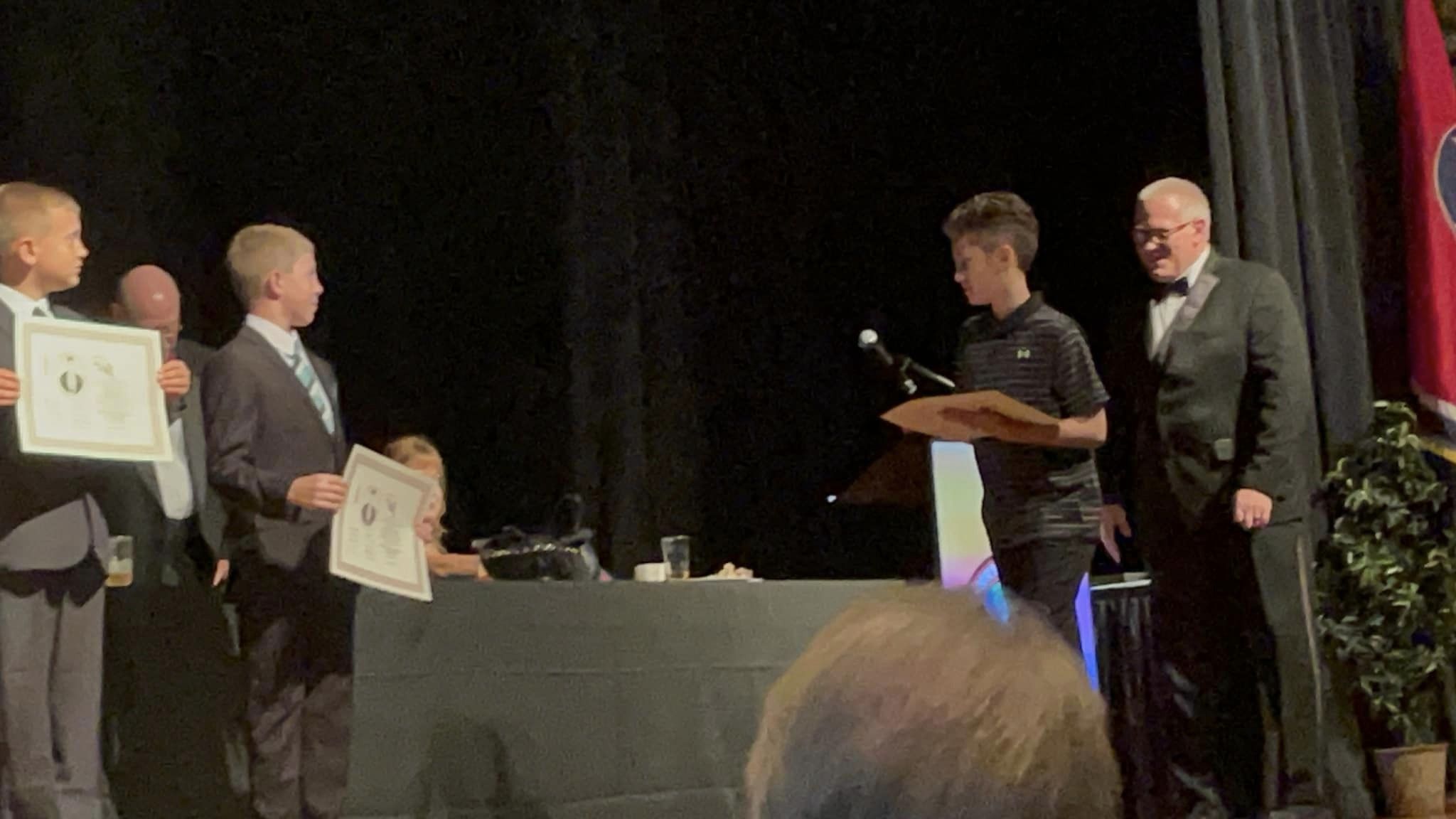 A martial artist receiving recognition during an awards presentation