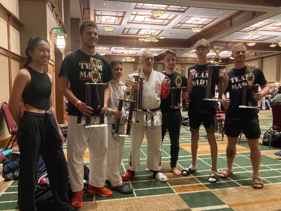 Team Mady group posing at a martial arts awards event