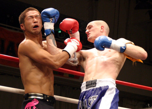 Boxing competitors exchanging punches with red and blue gloves