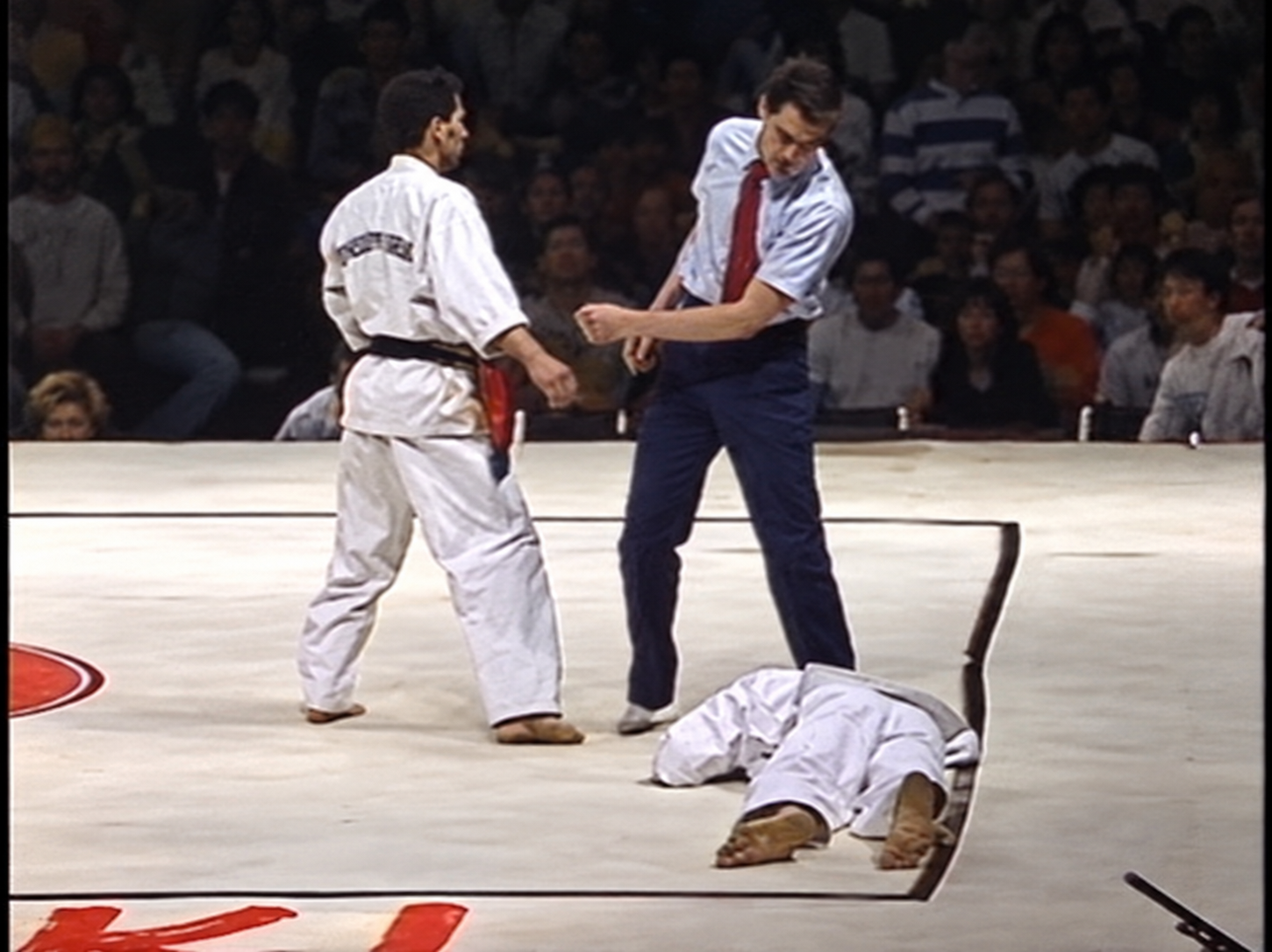 Albert Mady during an archival martial arts demonstration with a staff and training partners