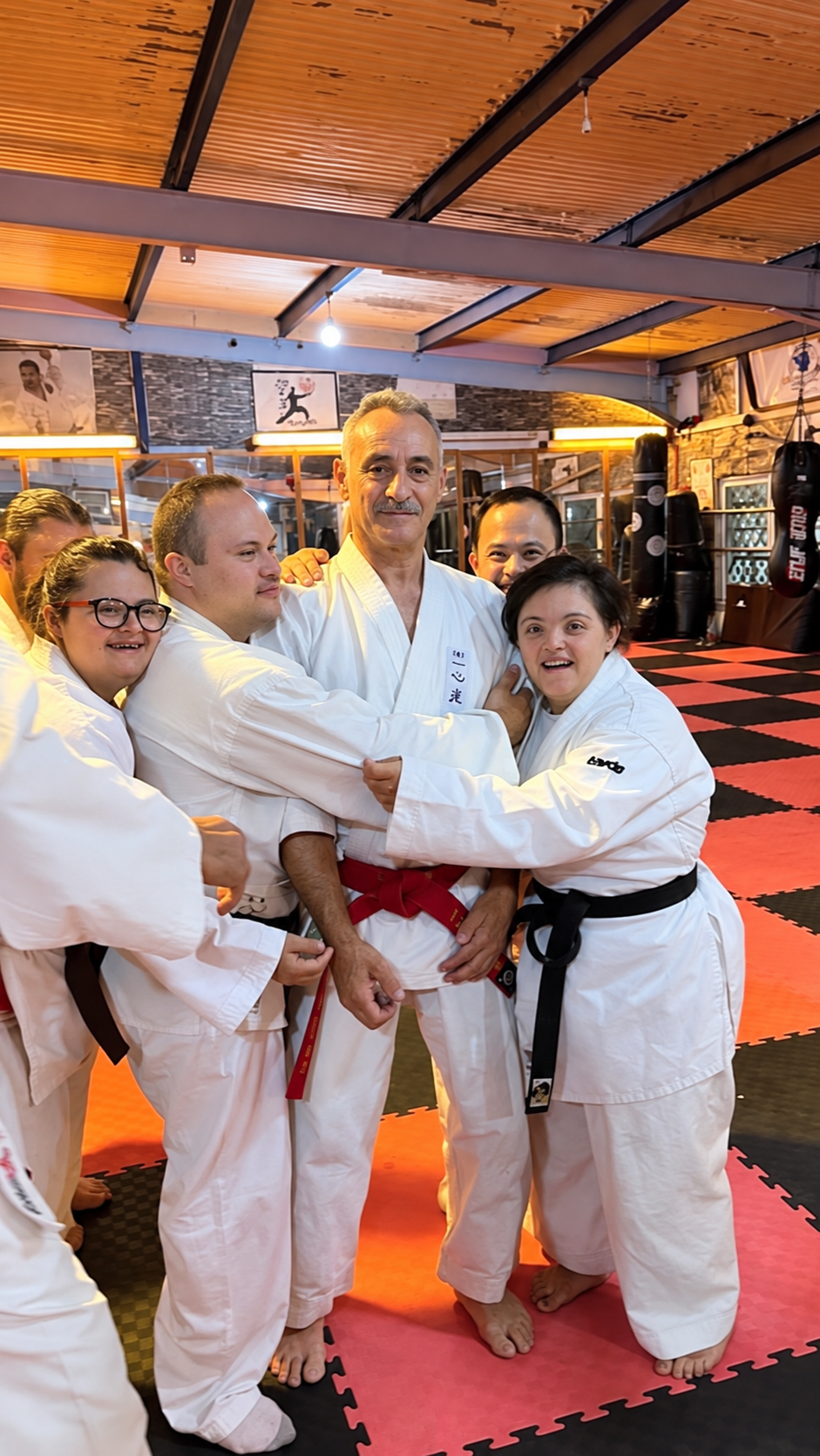 Albert Mady with students gathered around him at the dojo